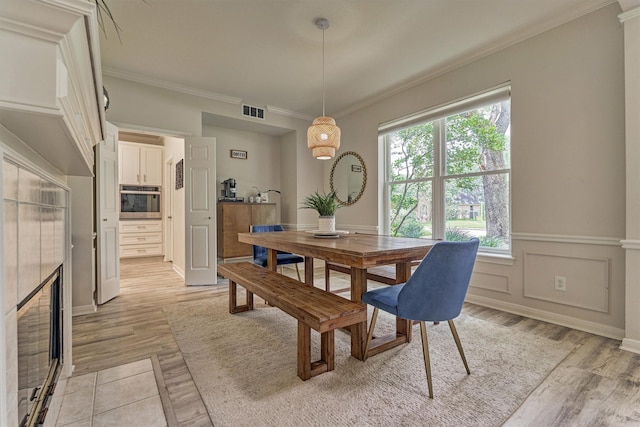 22811 Northampton Pines Dr, Spring, TX 77389 - dining space featuring crown molding and light wood finished floors
