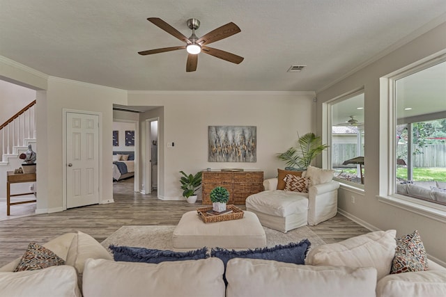 22811 Northampton Pines Dr, Spring, TX 77389 - living area featuring ceiling fan, crown molding, stairs, and wood finished floors