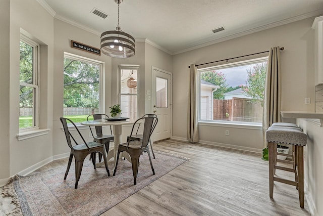 22811 Northampton Pines Dr, Spring, TX 77389 - dining area with healthy amount of natural light, light wood-style floors, a chandelier, and crown molding