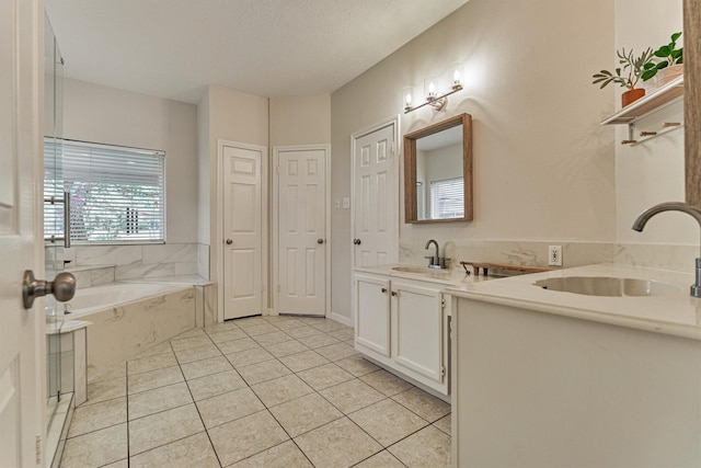 22811 Northampton Pines Dr, Spring, TX 77389 - full bathroom with double vanity, a garden tub, and tile patterned flooring