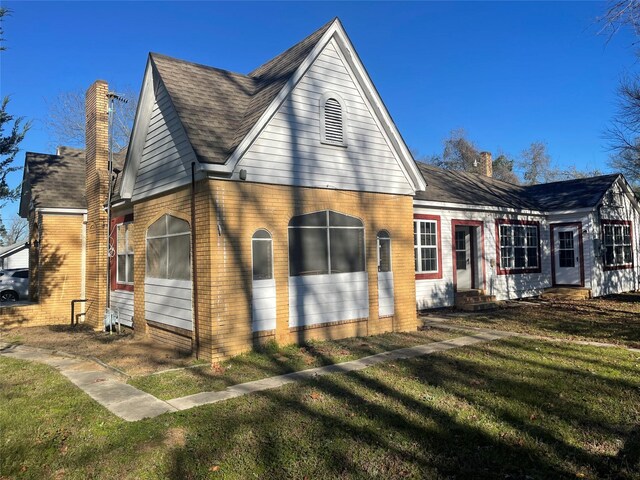 926 S Cass St, Centerville, TX 75833 - view of side of home with a chimney, brick siding, and a yard