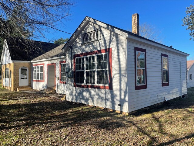926 S Cass St, Centerville, TX 75833 - view of side of home featuring a chimney and a yard