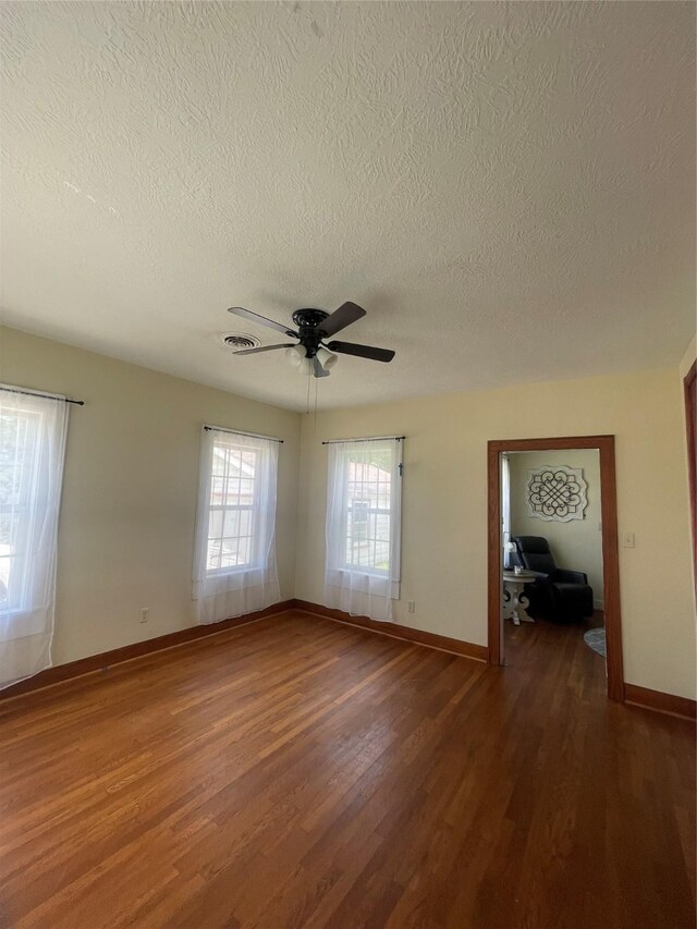 926 S Cass St, Centerville, TX 75833 - empty room featuring a textured ceiling, wood finished floors, and a ceiling fan