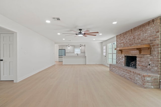 8215 Twining Oaks Ln, Spring, TX 77379 - unfurnished living room with a ceiling fan, light wood finished floors, recessed lighting, and a brick fireplace