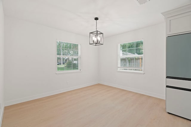 8215 Twining Oaks Ln, Spring, TX 77379 - spare room featuring plenty of natural light, light wood finished floors, and a chandelier