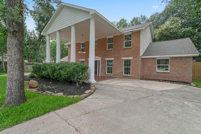 8215 Twining Oaks Ln, Spring, TX 77379 - greek revival inspired property featuring brick siding, roof with shingles, and driveway
