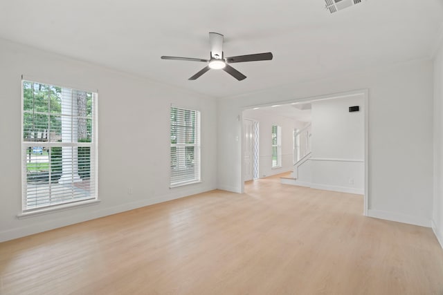 8215 Twining Oaks Ln, Spring, TX 77379 - spare room with light wood finished floors, a ceiling fan, ornamental molding, and stairway