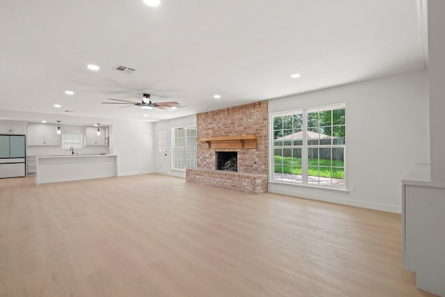 8215 Twining Oaks Ln, Spring, TX 77379 - unfurnished living room featuring recessed lighting, ceiling fan, a fireplace, and light wood finished floors
