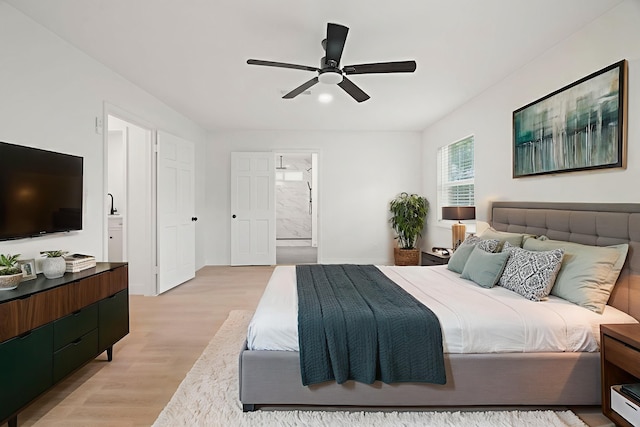 8215 Twining Oaks Ln, Spring, TX 77379 - bedroom featuring light wood-style flooring, ensuite bath, and ceiling fan