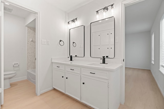 8215 Twining Oaks Ln, Spring, TX 77379 - full bath featuring wood finished floors, double vanity, and shower / bath combination