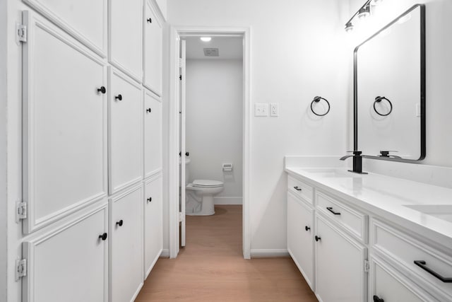 8215 Twining Oaks Ln, Spring, TX 77379 - full bathroom featuring double vanity, wood finished floors, and a closet