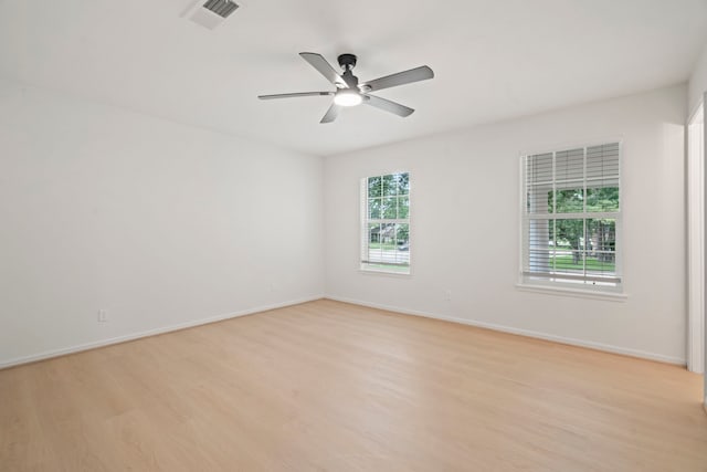 8215 Twining Oaks Ln, Spring, TX 77379 - empty room with healthy amount of natural light, light wood-style flooring, and ceiling fan