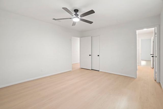 8215 Twining Oaks Ln, Spring, TX 77379 - unfurnished bedroom with light wood-type flooring, ceiling fan, and a closet