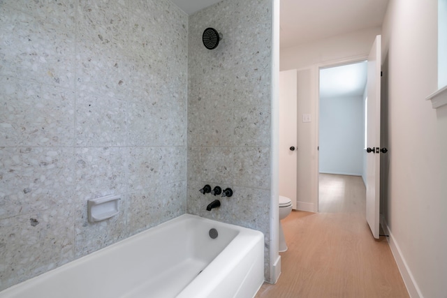 8215 Twining Oaks Ln, Spring, TX 77379 - full bathroom with wood finished floors and bathing tub / shower combination