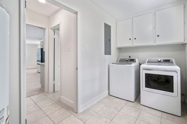 8215 Twining Oaks Ln, Spring, TX 77379 - washroom with separate washer and dryer, light tile patterned flooring, electric panel, and cabinet space