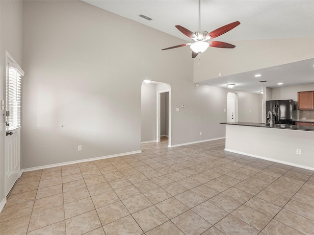 419 Eastern Phoebe, San Antonio, TX 78253 - unfurnished living room with arched walkways, ceiling fan, high vaulted ceiling, and light tile patterned floors