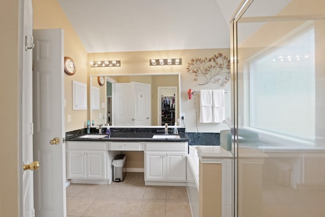 18114 Rustic Springs Dr, Tomball, TX 77375 - bathroom featuring double vanity, tile patterned flooring, and a shower with shower door
