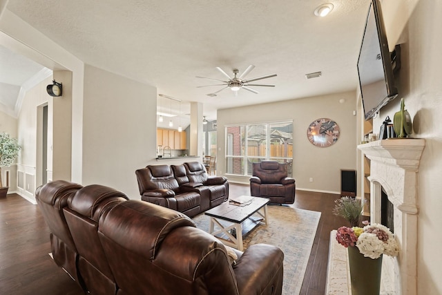 18114 Rustic Springs Dr, Tomball, TX 77375 - living room featuring a ceiling fan, dark wood-type flooring, and a fireplace