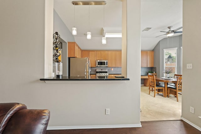 18114 Rustic Springs Dr, Tomball, TX 77375 - kitchen with stainless steel appliances, lofted ceiling, decorative backsplash, ceiling fan, and dark countertops