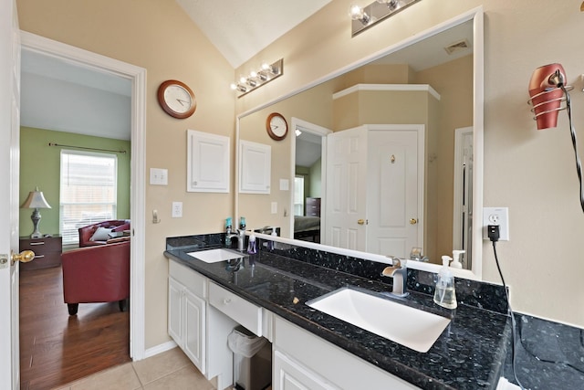 18114 Rustic Springs Dr, Tomball, TX 77375 - ensuite bathroom featuring vaulted ceiling, double vanity, and tile patterned floors