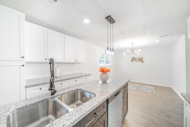 8318 Hanfro Ln, Houston, TX 77088 - kitchen with dishwasher, a textured ceiling, white cabinetry, decorative light fixtures, and light wood-type flooring