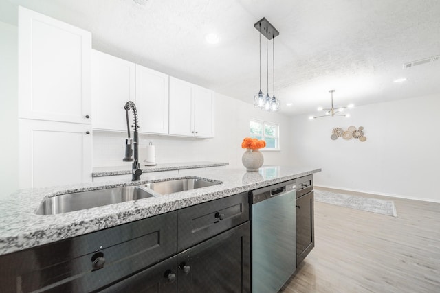 8318 Hanfro Ln, Houston, TX 77088 - kitchen featuring dishwasher, white cabinets, pendant lighting, light stone countertops, and light wood-style floors