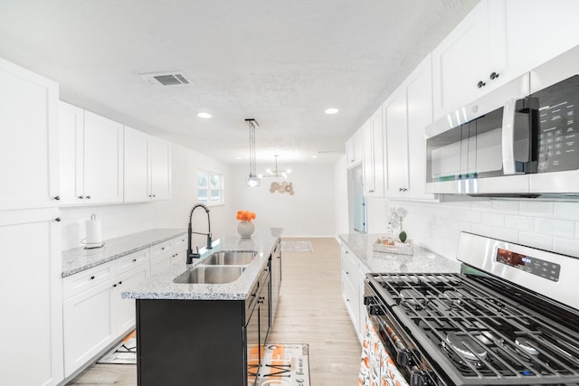 8318 Hanfro Ln, Houston, TX 77088 - kitchen with appliances with stainless steel finishes, light wood-style flooring, white cabinets, and recessed lighting