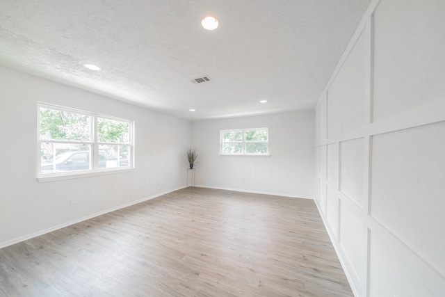 8318 Hanfro Ln, Houston, TX 77088 - empty room with light wood-style floors and recessed lighting