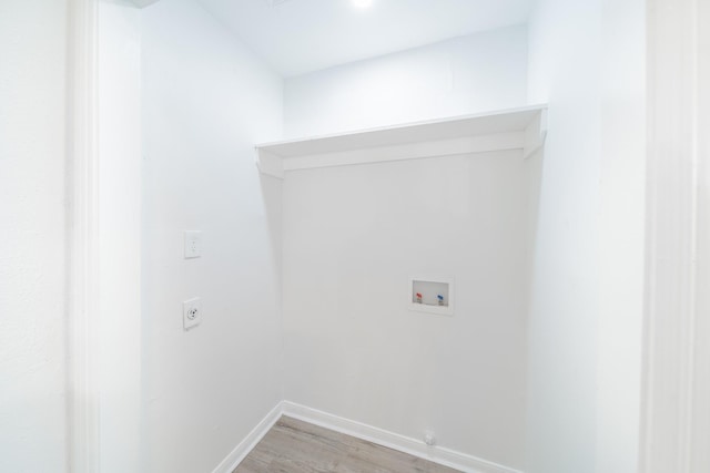 8318 Hanfro Ln, Houston, TX 77088 - washroom featuring washer hookup, electric dryer hookup, and light wood-style flooring
