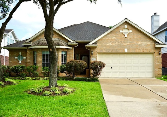 14811 Horse Creek Ln, Sugar Land, TX 77498 - view of front of house with an attached garage, driveway, a front yard, and brick siding