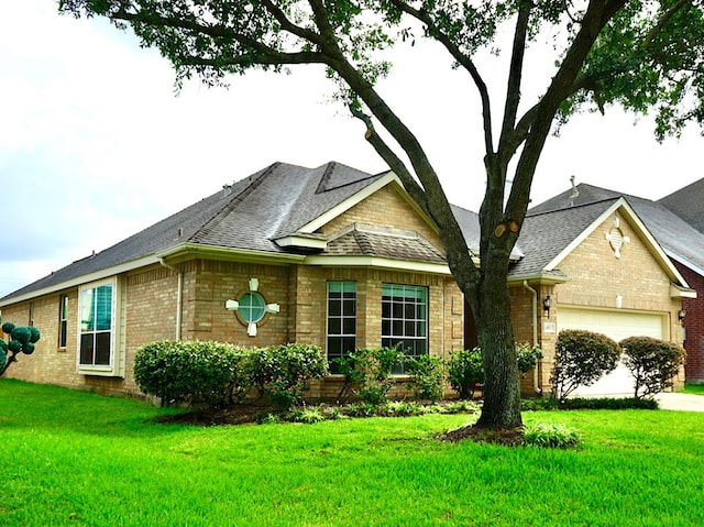 14811 Horse Creek Ln, Sugar Land, TX 77498 - view of front of property featuring an attached garage, brick siding, a front lawn, and roof with shingles