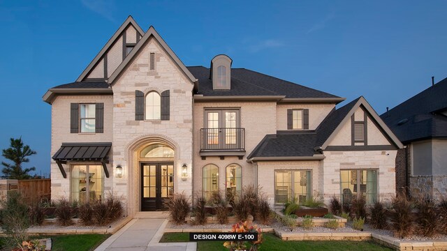 5603 Logan Ridge Ln, Fulshear, TX 77441 - view of front of house featuring french doors, a balcony, stone siding, and brick siding