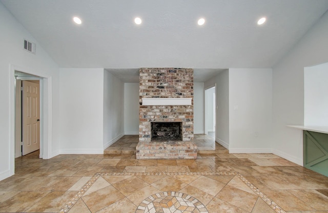 22710 Earlmist Dr, Spring, TX 77373 - unfurnished living room featuring stone tile flooring, a fireplace, recessed lighting, and inlaid floor details