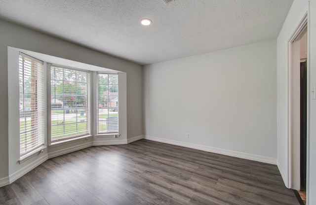 22710 Earlmist Dr, Spring, TX 77373 - spare room with a textured ceiling, dark wood-style floors, and recessed lighting