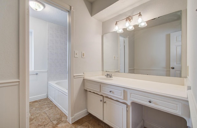 22710 Earlmist Dr, Spring, TX 77373 - bathroom featuring vanity, stone finish floors, and wainscoting