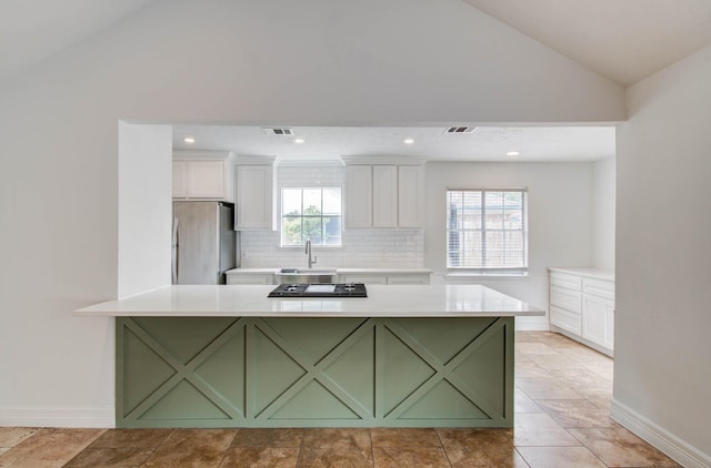 22710 Earlmist Dr, Spring, TX 77373 - kitchen with green cabinetry, freestanding refrigerator, vaulted ceiling, white cabinets, and plenty of natural light