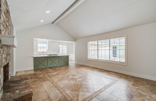 22710 Earlmist Dr, Spring, TX 77373 - unfurnished living room featuring beamed ceiling, a brick fireplace, high vaulted ceiling, a textured ceiling, and recessed lighting