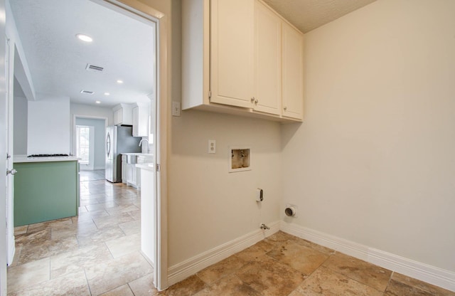 22710 Earlmist Dr, Spring, TX 77373 - laundry room featuring cabinet space, gas dryer hookup, hookup for a washing machine, stone tile flooring, and hookup for an electric dryer