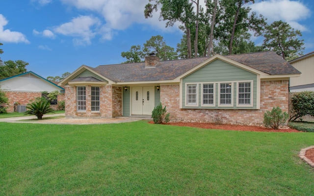 22710 Earlmist Dr, Spring, TX 77373 - single story home featuring brick siding, a front lawn, and a chimney
