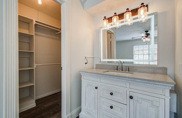 22710 Earlmist Dr, Spring, TX 77373 - bathroom with vanity, wood finished floors, a ceiling fan, and a spacious closet
