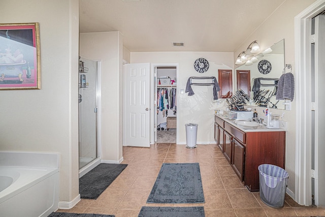 21530 Amesbury Meadow Ln, Spring, TX 77379 - full bath with double vanity, a bath, tile patterned floors, a stall shower, and a spacious closet