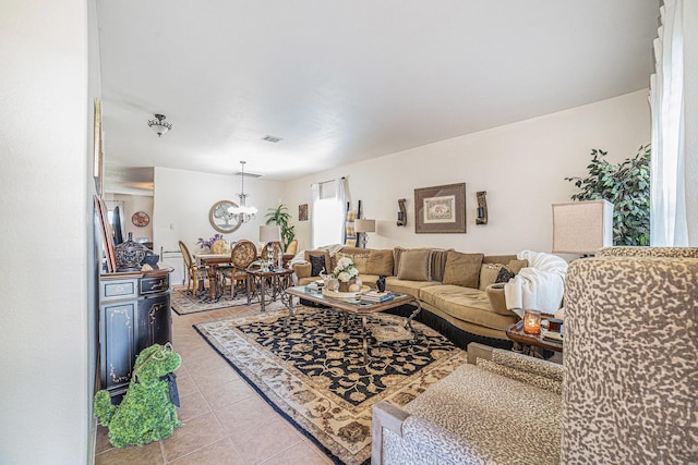 21530 Amesbury Meadow Ln, Spring, TX 77379 - living room with light tile patterned floors and a chandelier
