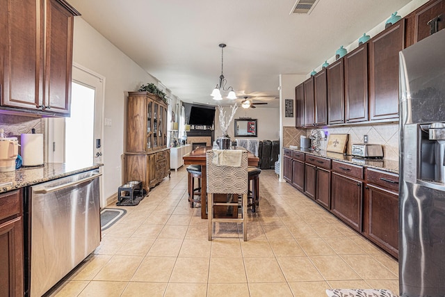 21530 Amesbury Meadow Ln, Spring, TX 77379 - kitchen featuring dishwasher, fridge with ice dispenser, backsplash, stone countertops, and open floor plan