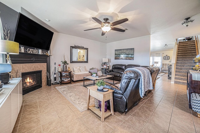 21530 Amesbury Meadow Ln, Spring, TX 77379 - living area with stairs, light tile patterned floors, a ceiling fan, and a fireplace