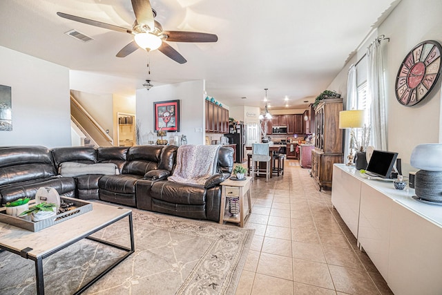 21530 Amesbury Meadow Ln, Spring, TX 77379 - living room with ceiling fan, light tile patterned floors, healthy amount of natural light, and stairs