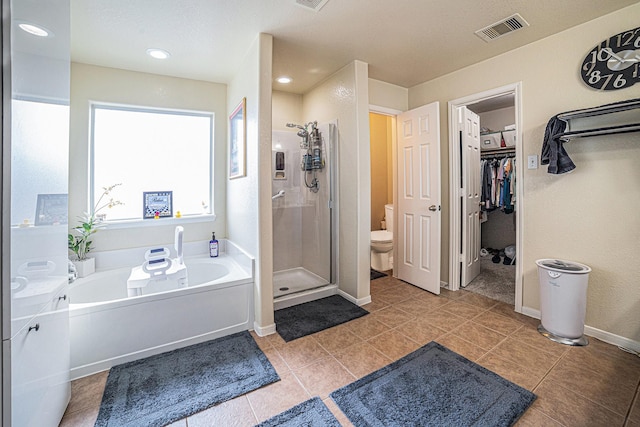 21530 Amesbury Meadow Ln, Spring, TX 77379 - bathroom with a garden tub, a stall shower, tile patterned floors, and a walk in closet