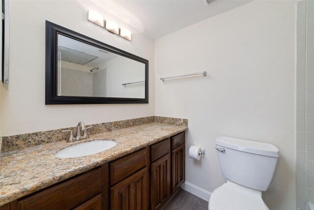 2601 S Braeswood Blvd Unit 302, Houston, TX 77025 - bathroom with vanity, wood finished floors, and a shower