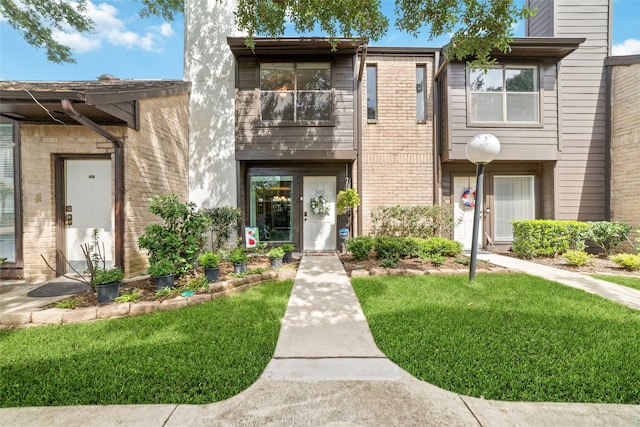2601 S Braeswood Blvd Unit 302, Houston, TX 77025 - view of front of property with a front yard and brick siding