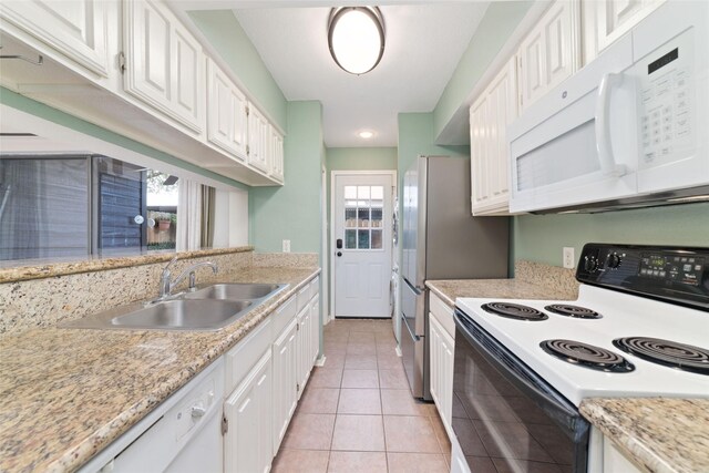 2601 S Braeswood Blvd Unit 302, Houston, TX 77025 - kitchen with white appliances, white cabinetry, and light tile patterned floors