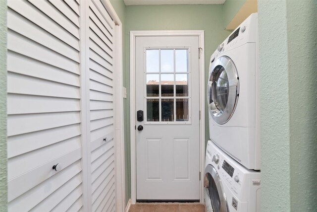 2601 S Braeswood Blvd Unit 302, Houston, TX 77025 - washroom with stacked washer / drying machine and tile patterned flooring